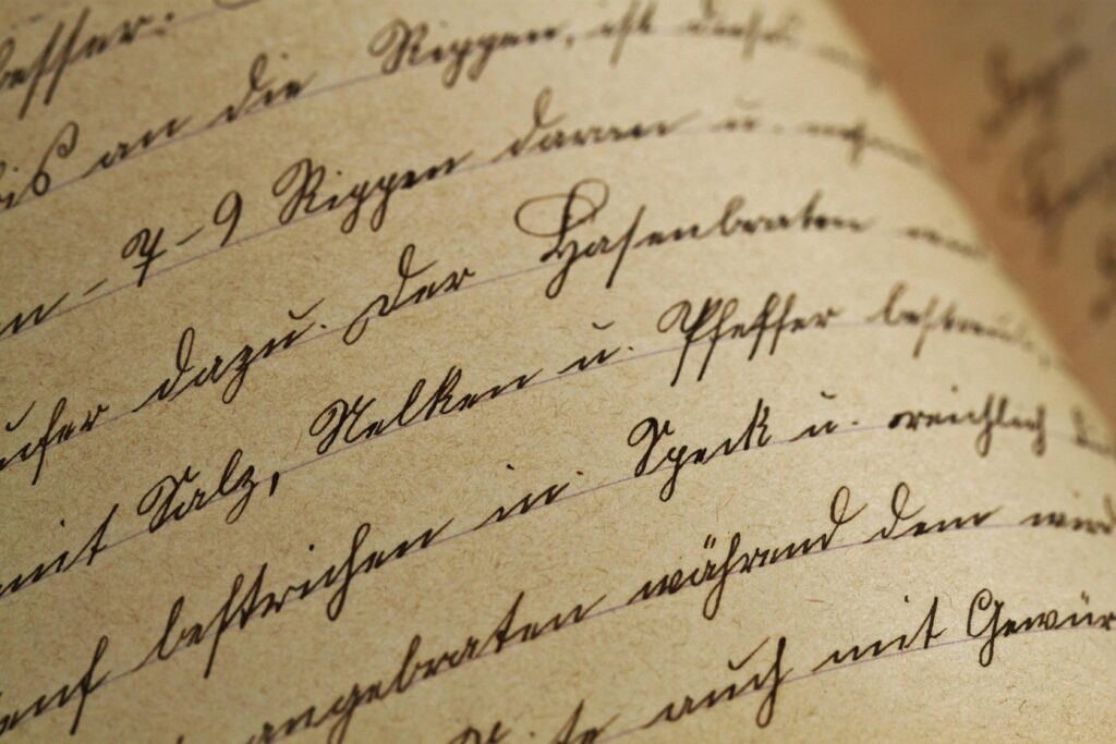 texture-handwriting-sutterlin-vintage-99562-99562 Close-up of vintage handwriting on antique aged paper with sepia tones.